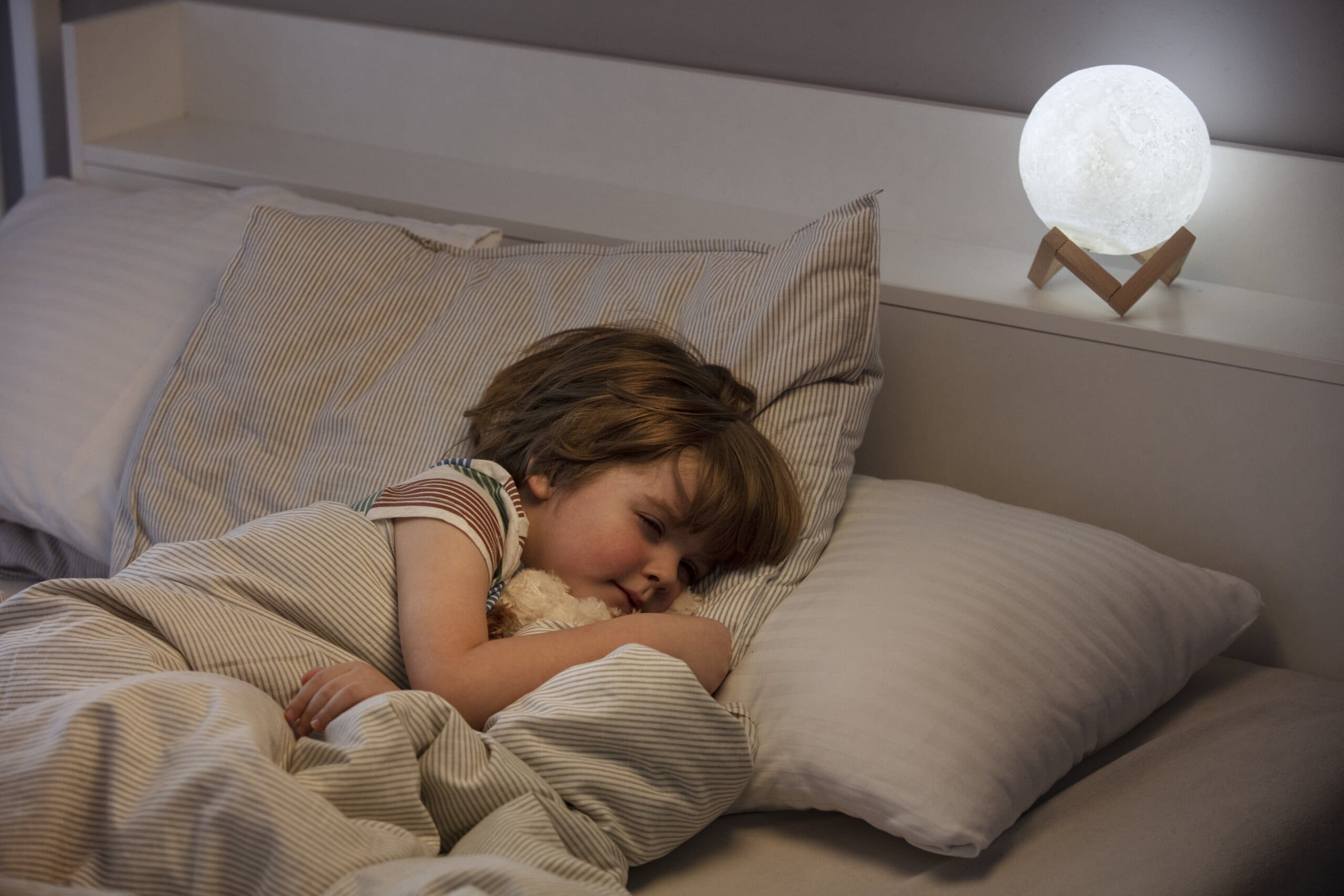 Young child sleeping in bed.