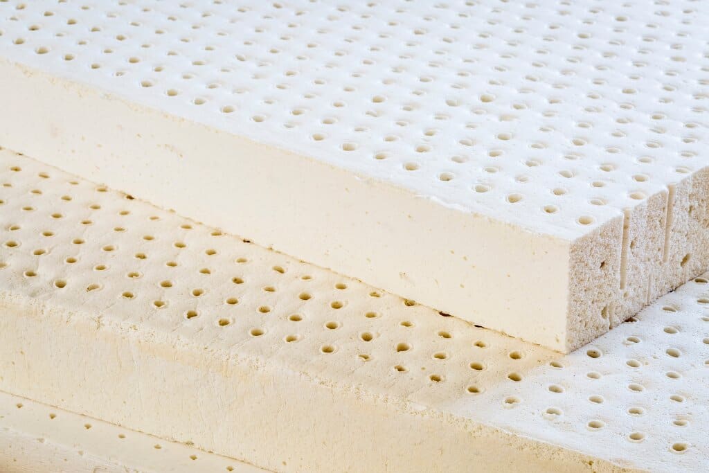 Exposed layers of natural latex from a latex foam mattress.