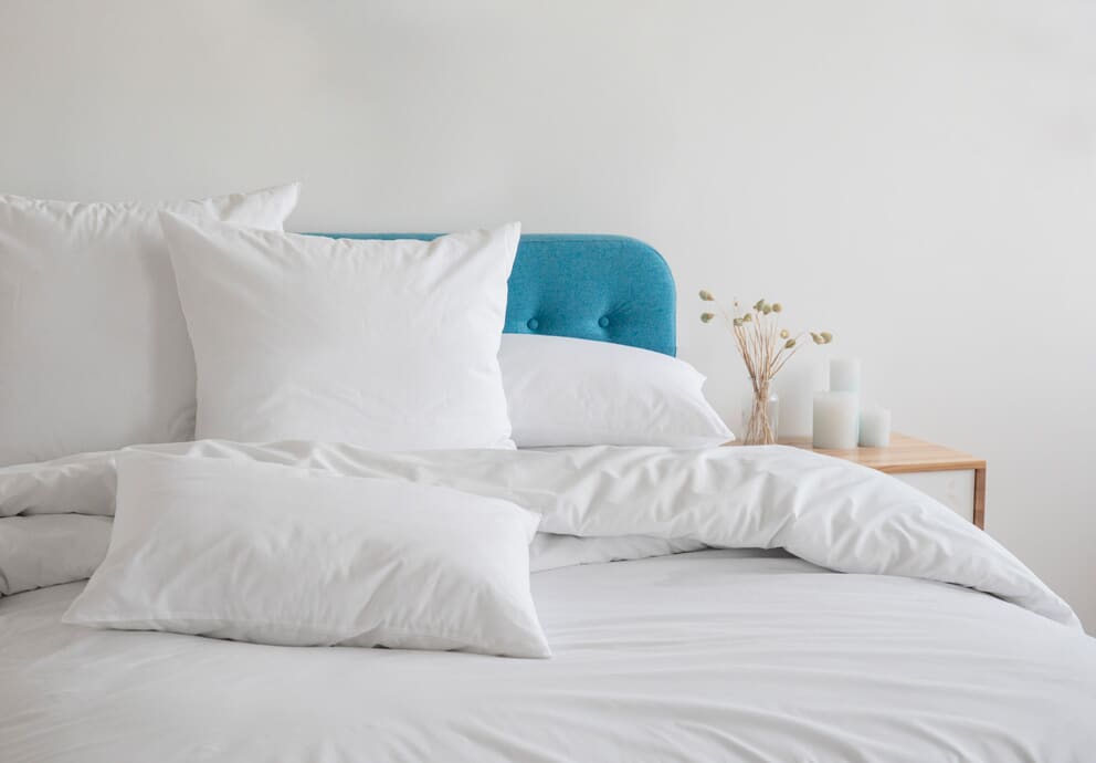 Close up of white pillows on a white bed
