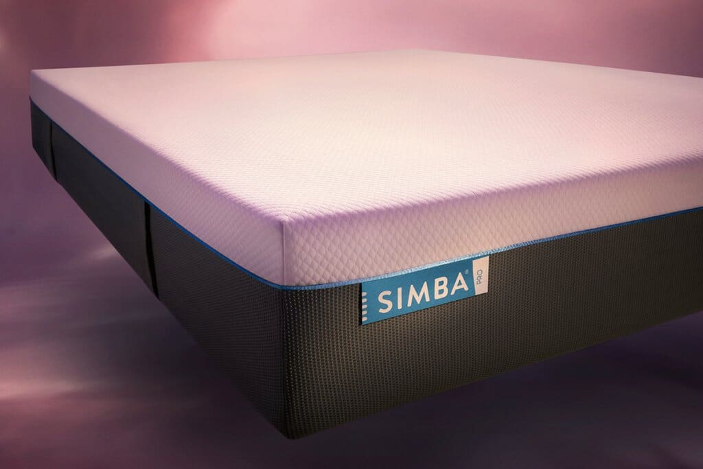 Close up of the corner of a simba hybrid pro mattress. Background is galaxy/space inspired.