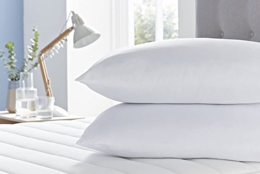Close up image of a pair of Silentnight Cooler Summer Pillows on white bed