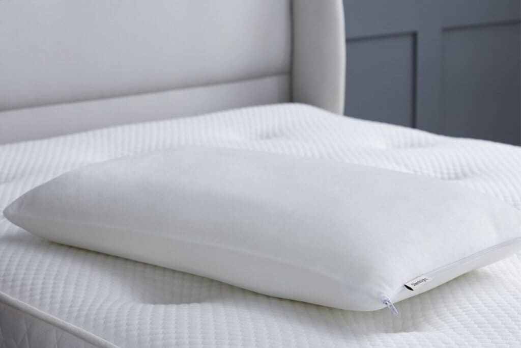 A Silentnight Impress Memory Foam Pillow lying on top of a white mattress