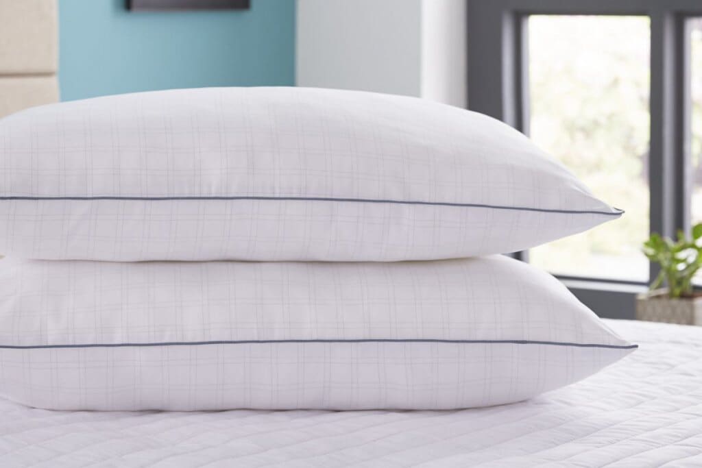 Close up of a pair of Silentnight Wellbeing Collection Re-balance Pillows, on top of a white mattress