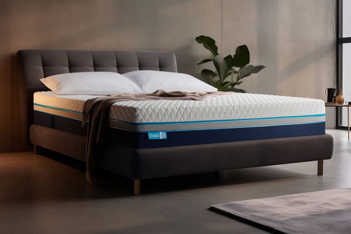 A dark room with the Simba Hybrid Luxe on a dark bed frame in a modern setting.