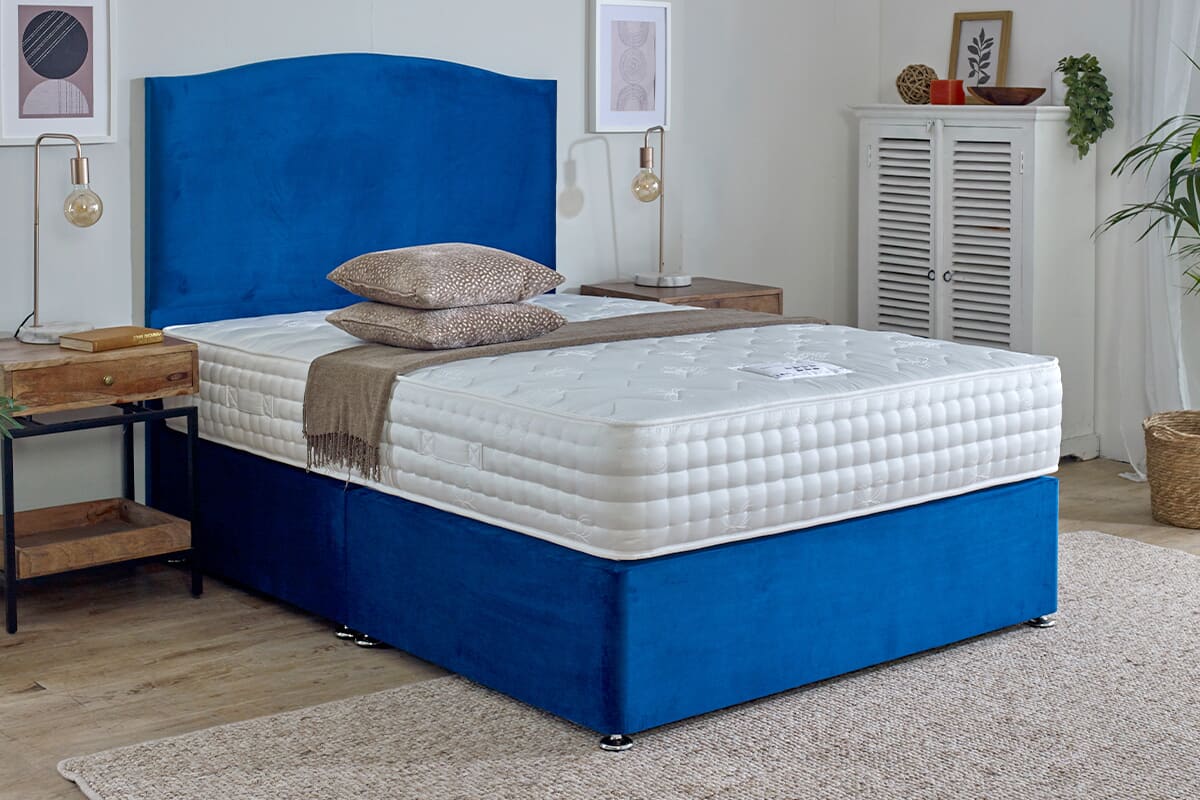 The Spring King Wool Luxury Soft mattress on a blue divan bed.