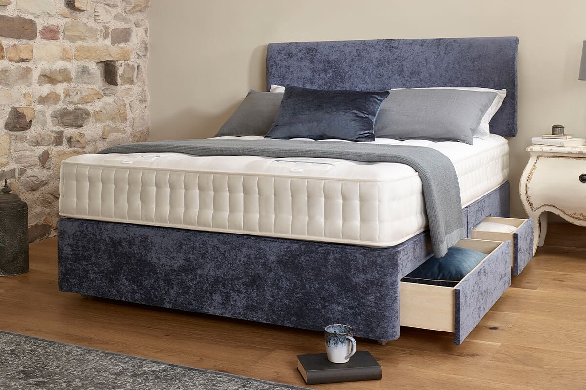 The Harrison Spinks Canterbury mattress on a blue divan bed.
