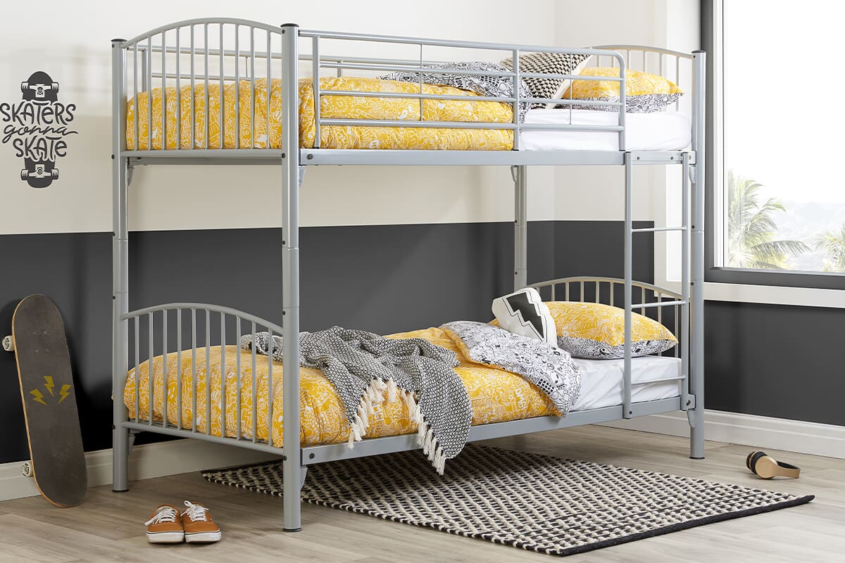 Lifestyle image of the grey Corfu bunk bed with yellow bedding.