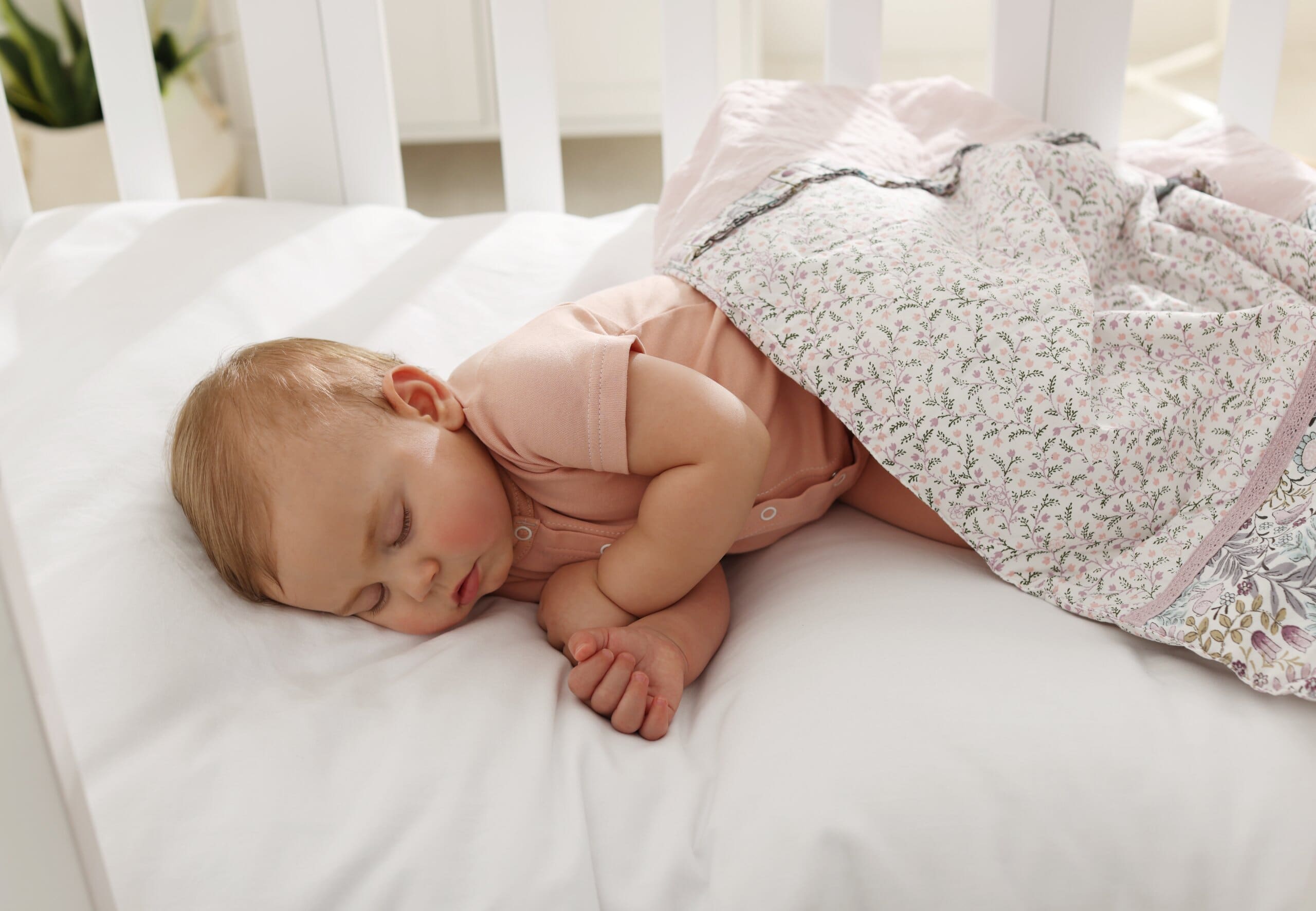 Baby sleeping in a cot bed.