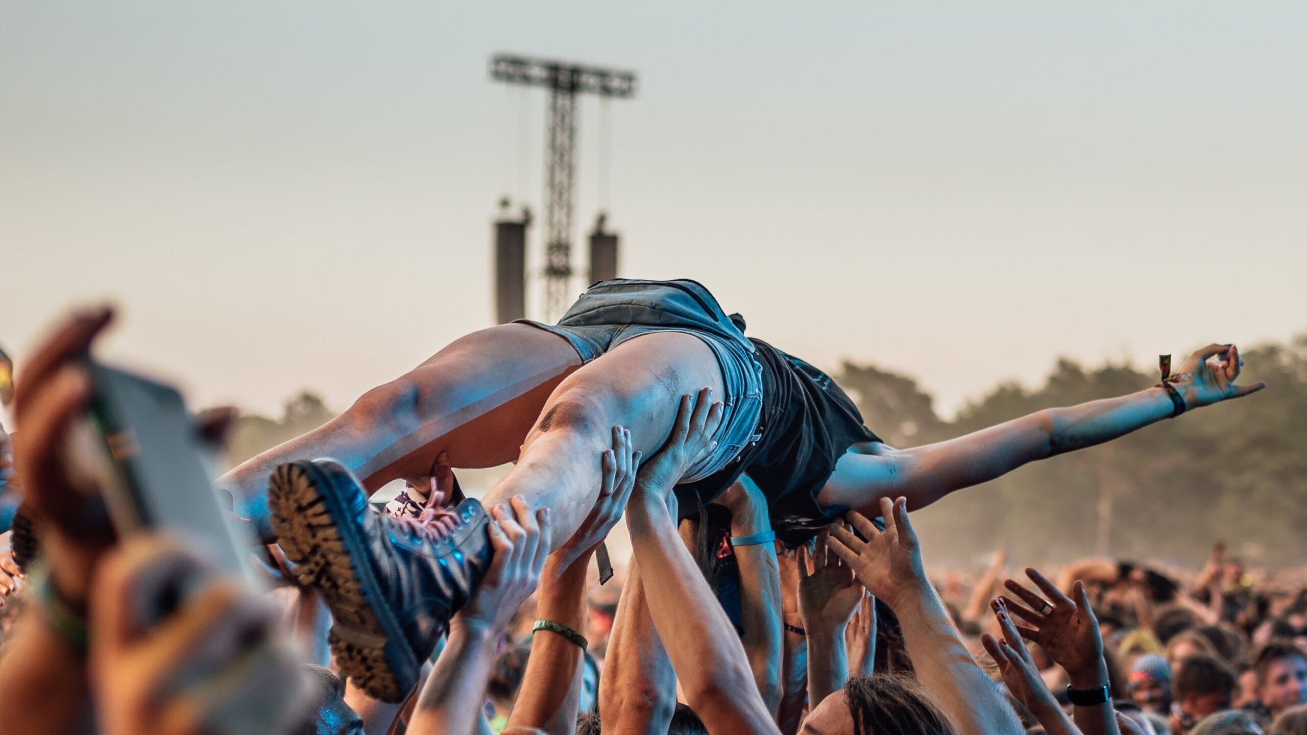 Person crowd surfing at a festival.
