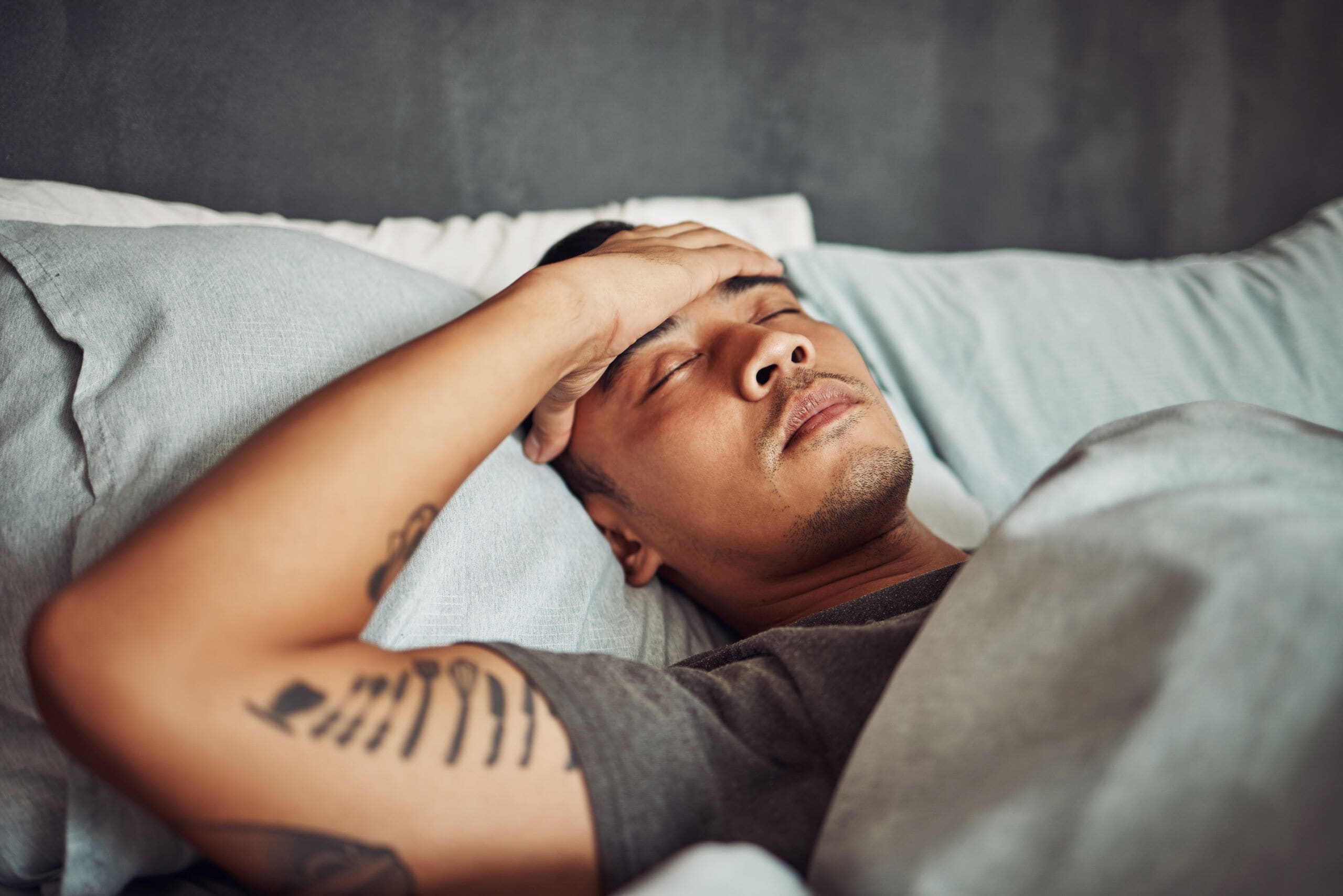 Man suffering from fever in bed.