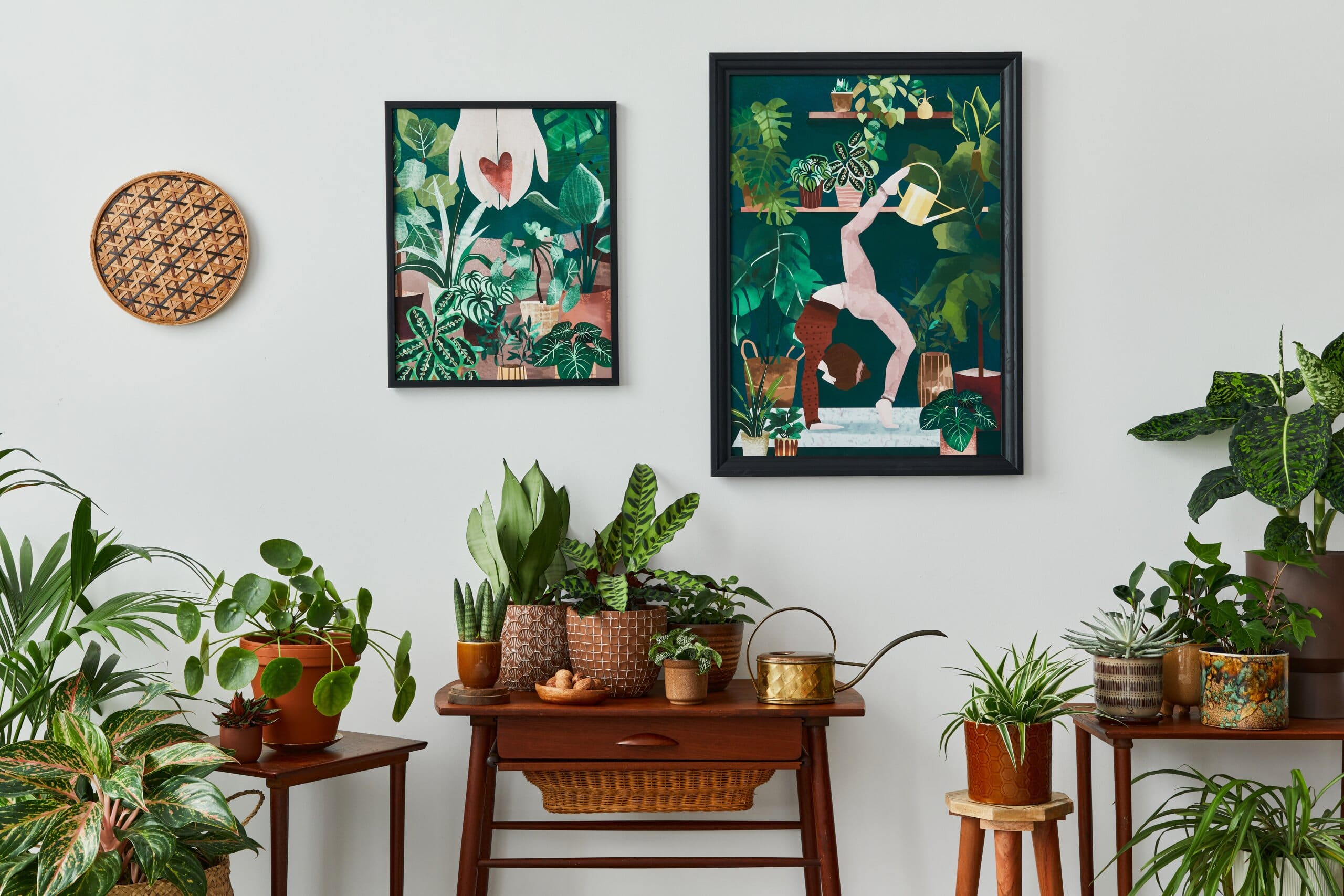 Image of a home interior with lots of houseplants and some prints on the wall in a maximalist style.
