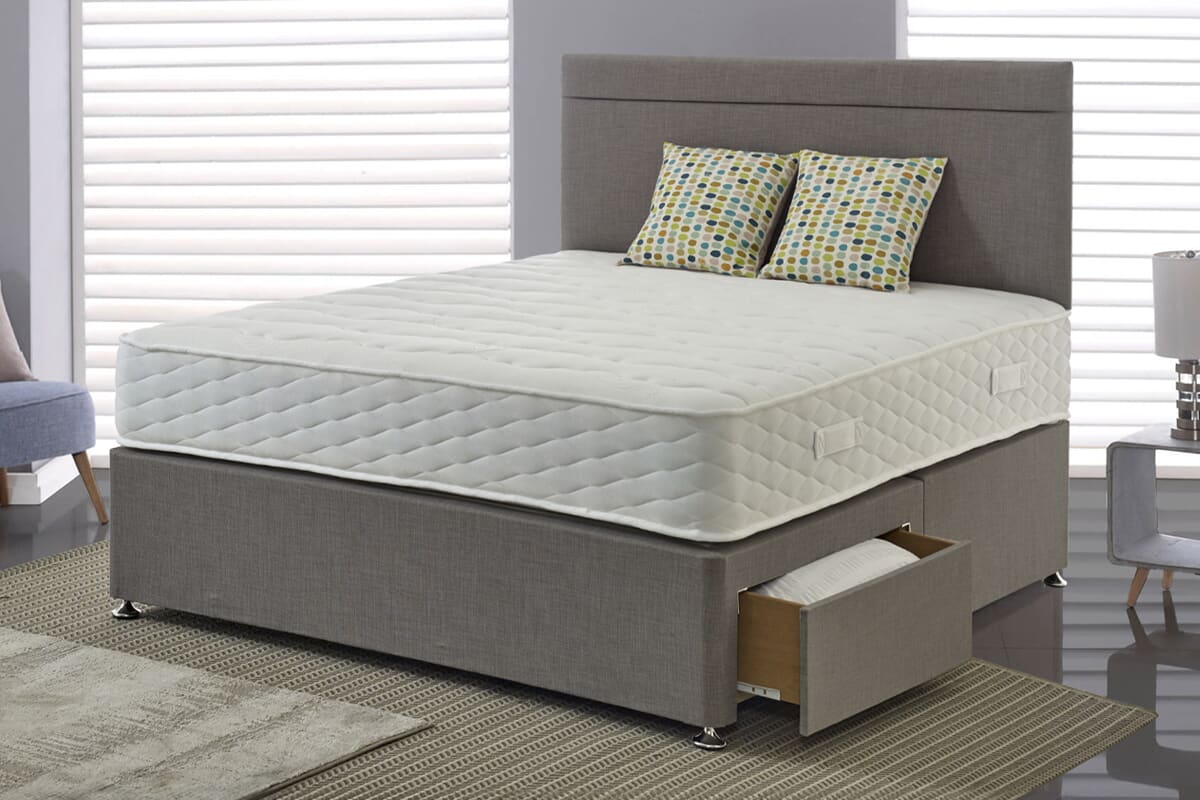 The Jasmine mattress on a grey divan bed with drawers.