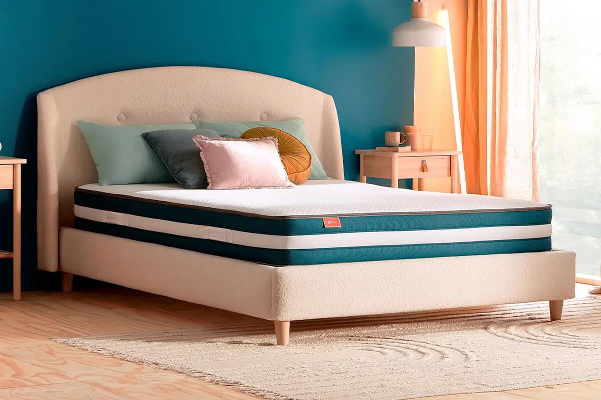 Image of the modern silentnight just bliss mattress in a blue bedroom on a beige bed frame.