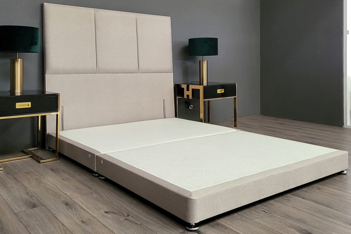 Lifestyle image of a simple low divan bed base with headboard.
