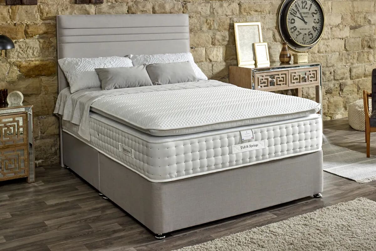 Image of the mattress on a grey divan bed.