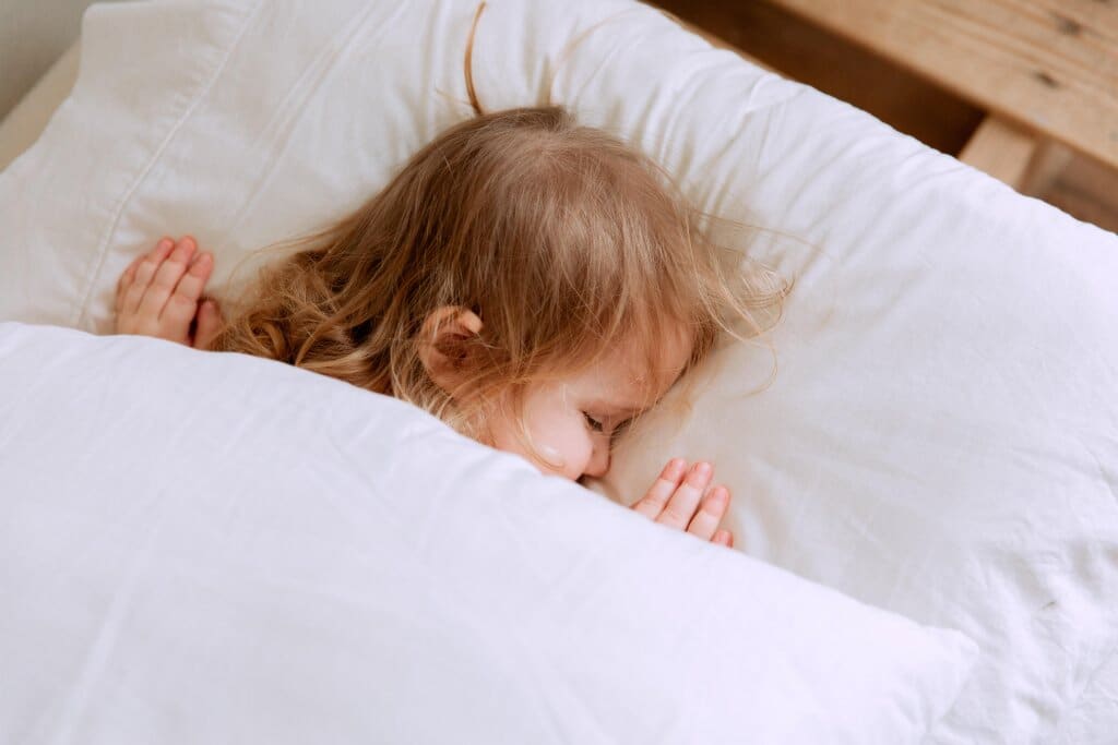 Close up of child asleep in bed