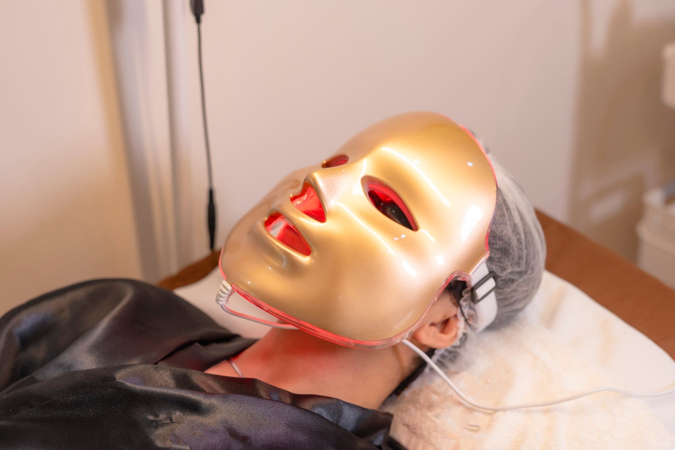 Man using a red light therapy mask.
