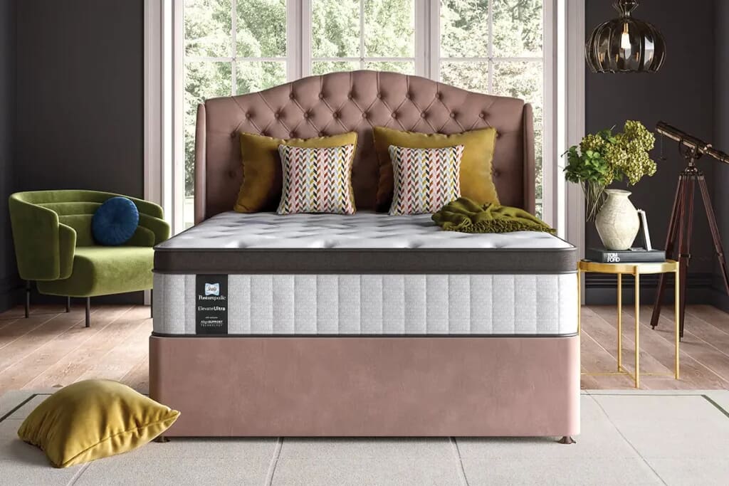 Lifestyle image of Sealy posturepedic mattress on an elegant light pink divan base with headboard.