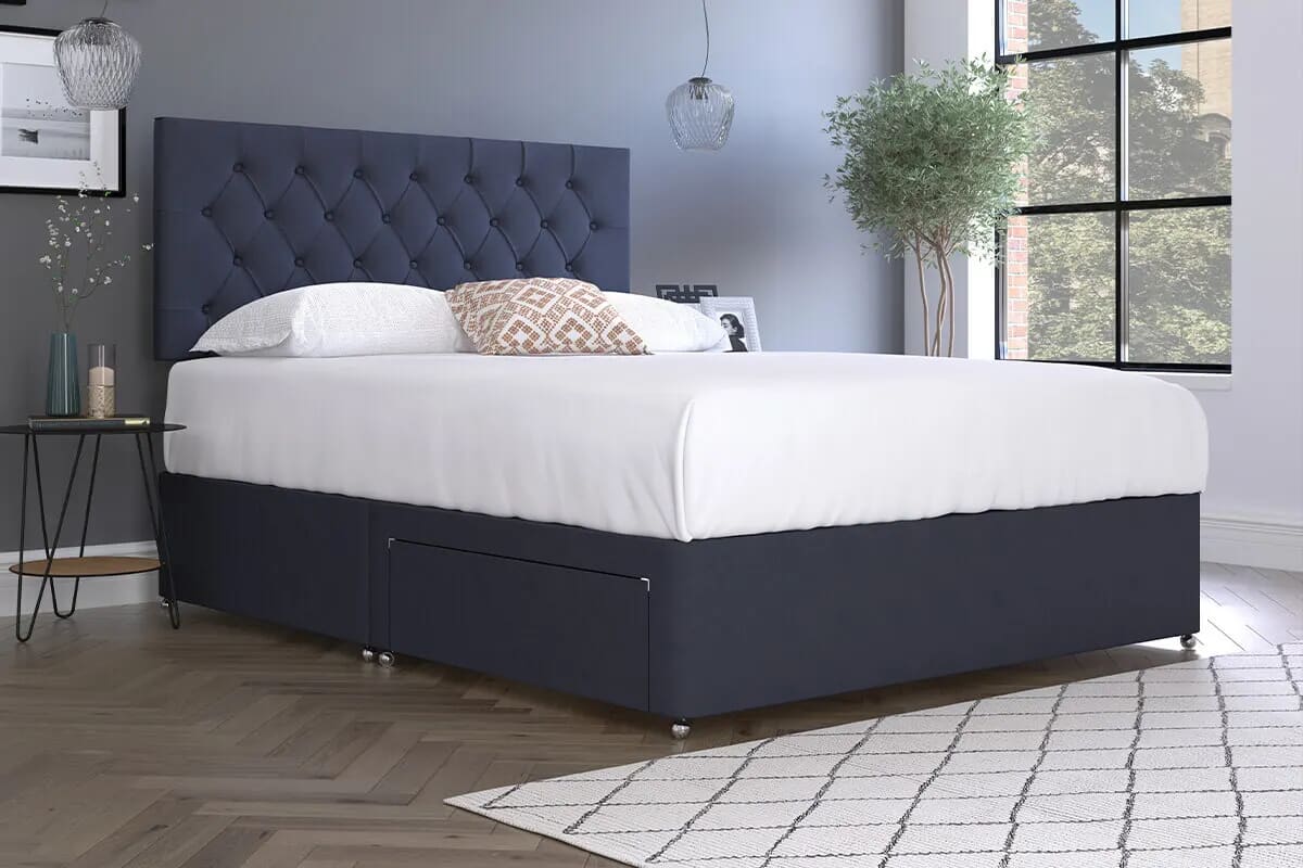 Image of blue divan bed with white bedding.