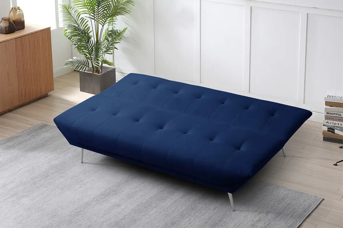 Folded out dar kblue sofa bed in a contemporary living room.
