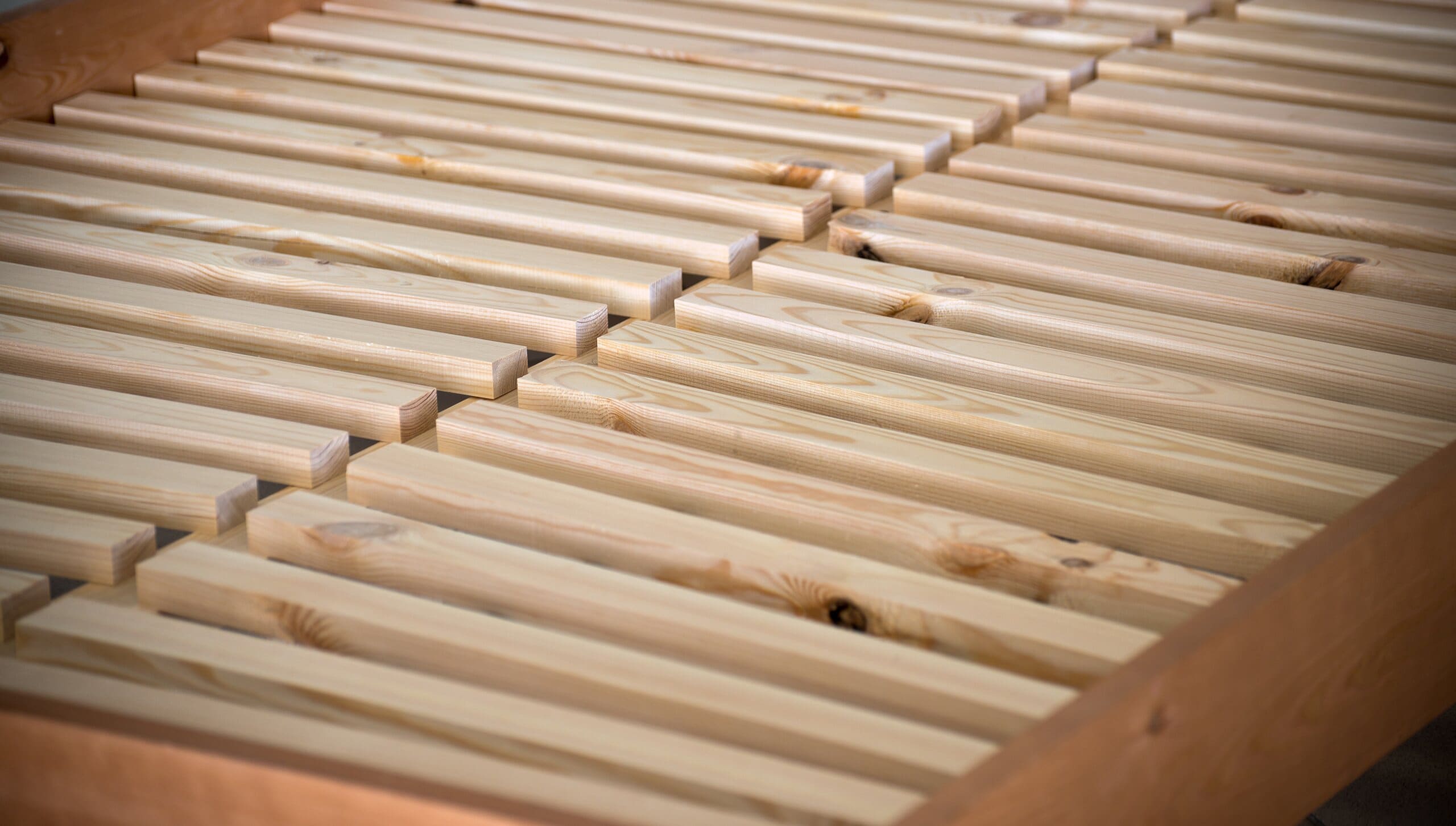 Close up of solid wooden slats on a bed base.