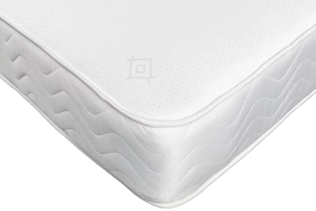 Close up corner of budget orthopaedic mattress on white background.