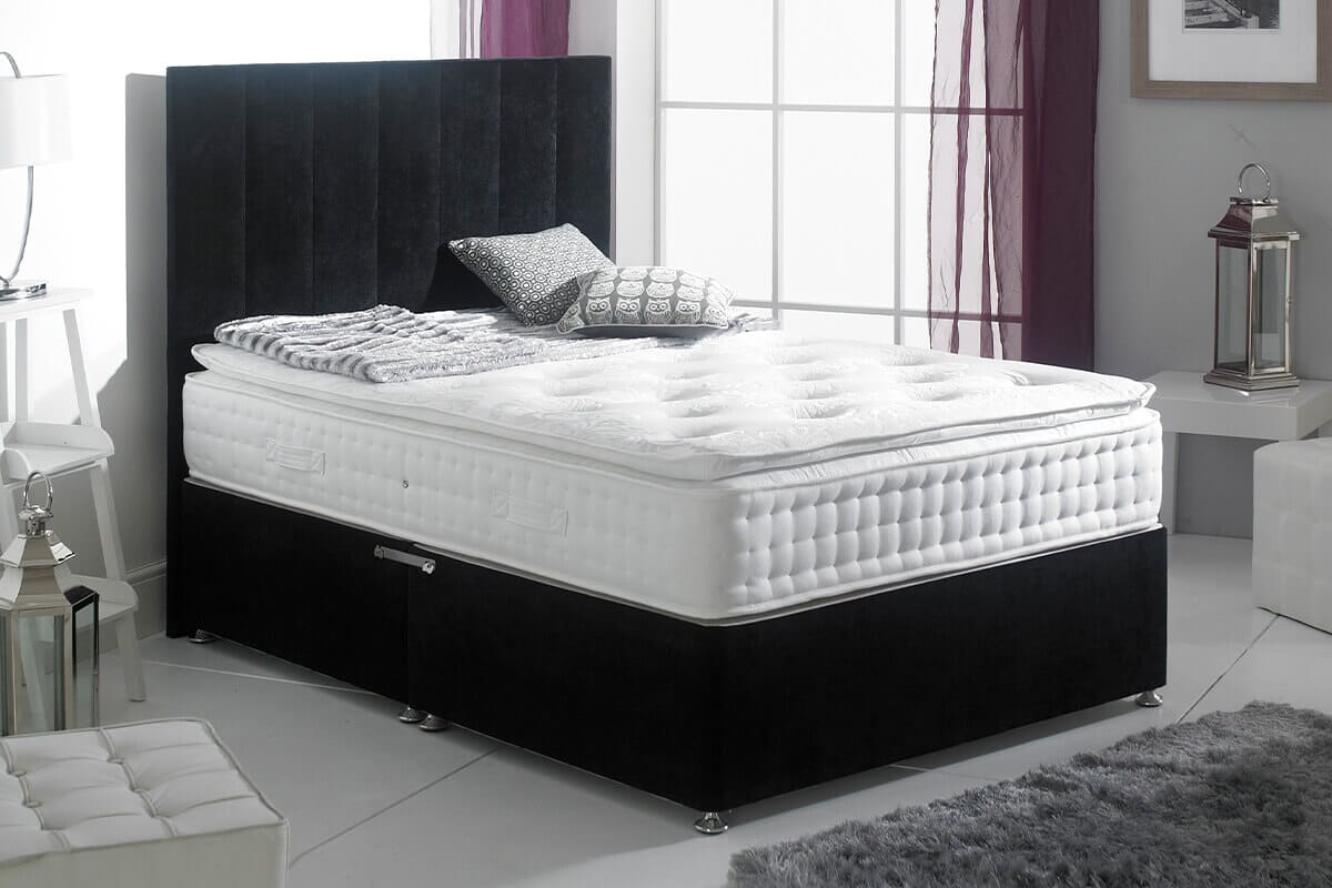Lifestyle image of the spring king sanctuary spa 2000 on a black upholstered divan bed.