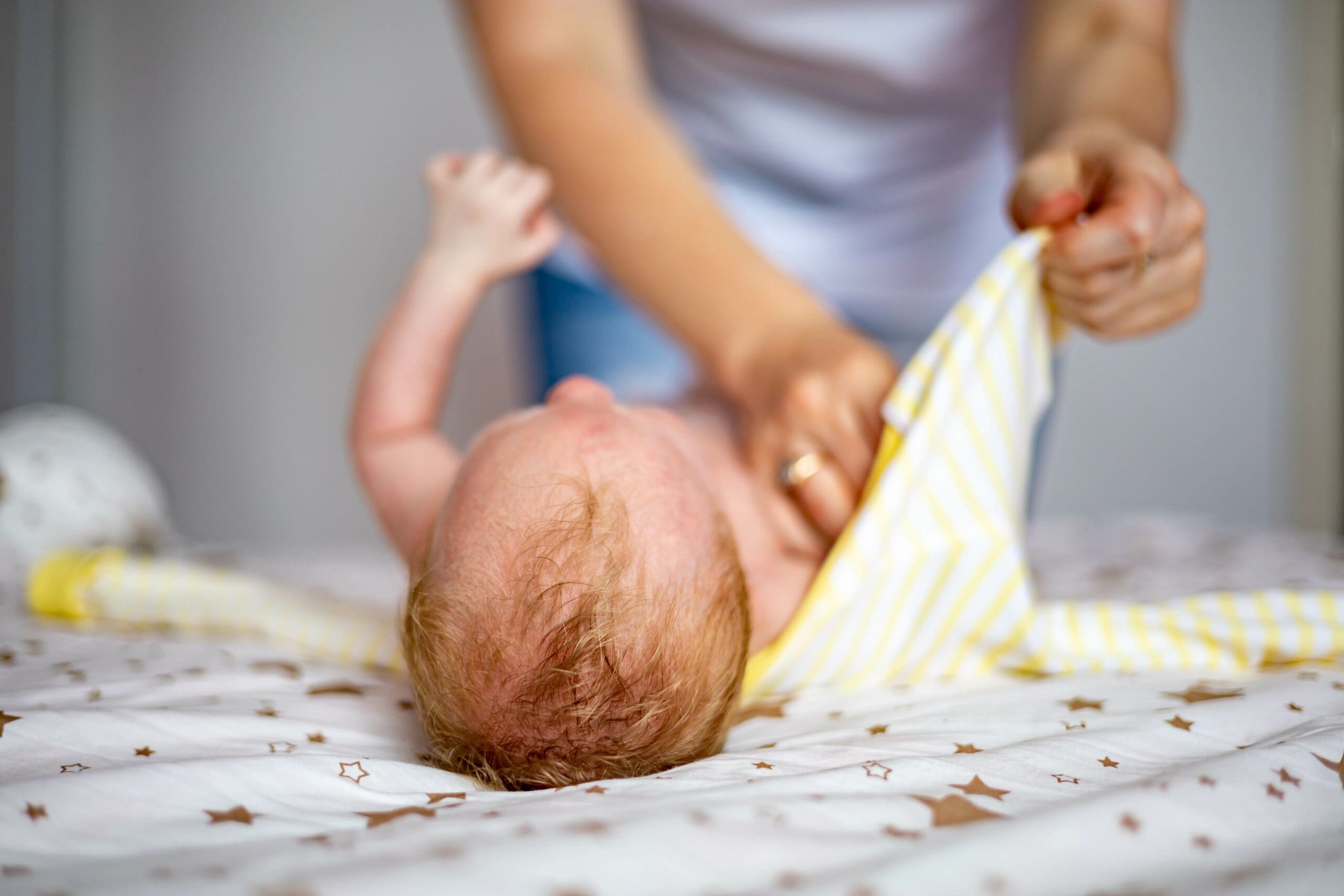 Top of baby's head as it's being swaddled.