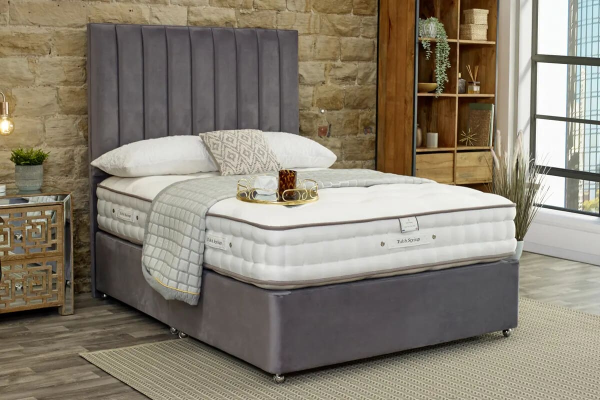 Image of the luxury temptation hybrid mattress on a grey divan bed.