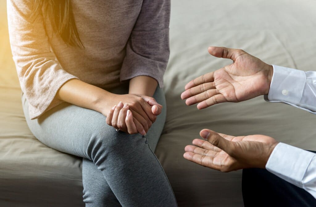 Man and woman's hands displaying a doctor giving advice to a patient.