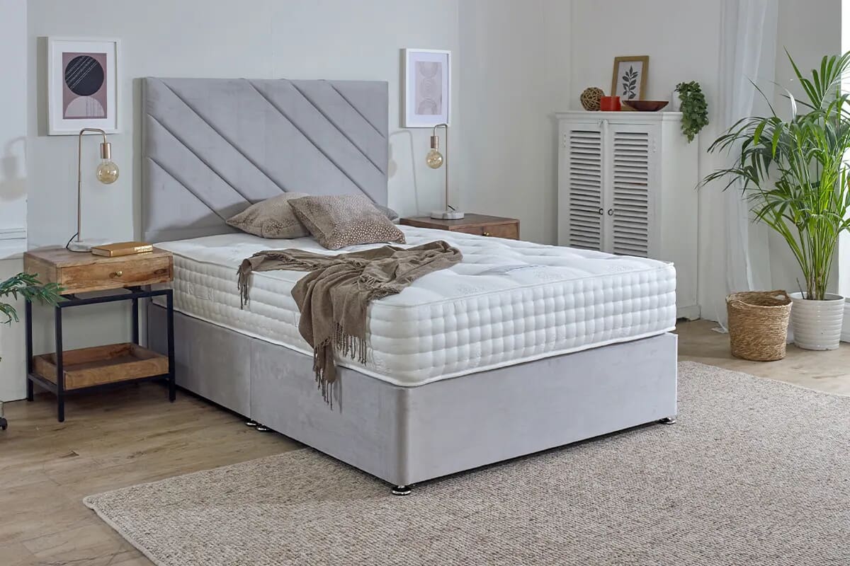 Image of the extra firm spring king mattress on a grey divan bed.
