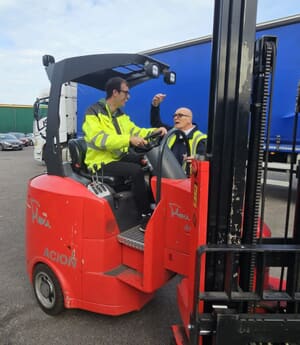 Ben operating a forklift in a warehouse.