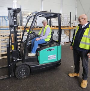 Deb operating a forklift in a warehouse.