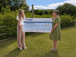 MattressNextDay holding a cheque with The Fifth Trust.