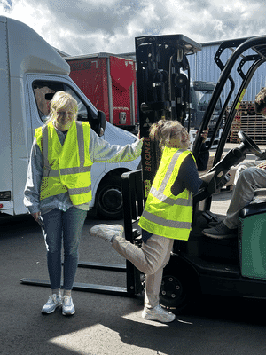 Fifth trust posing with the forklift.