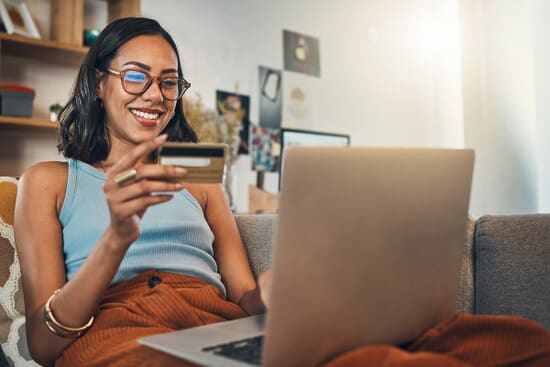 Person with bank card and laptop