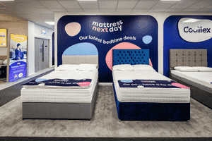 Close-up of MattressNextDay showroom display with modern bed frames and mattresses