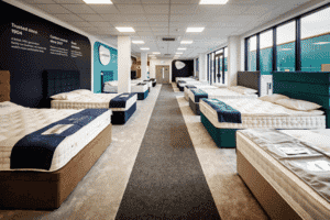 MattressNextDay showroom aisle with beds neatly arranged on display